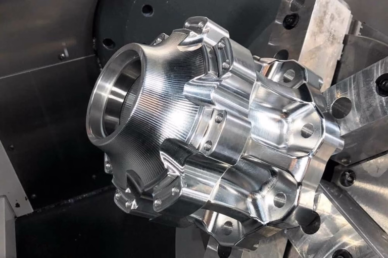 cnc machine service engineer reviewing a machined part on the shop floor